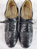 top view of 1930s black leather shoes