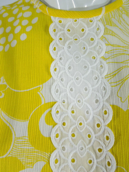 Boutique 60s/70s shift dress in yellow daisy print at Better Dresses Vintage. Texture close-up.