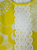 Boutique 60s/70s shift dress in yellow daisy print at Better Dresses Vintage. Texture close-up.