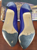 soles of 1980s purple leather pumps