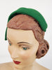 left side view of 1950's green sculptural hat