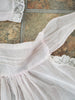 detail of pink, scalloped edge half apron