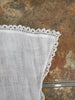 detail of lace on white pin apron