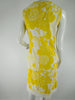 Boutique 60s/70s shift dress in yellow daisy print at Better Dresses Vintage. Back view.