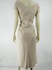 Vintage 1950s or 60s taupe wiggle dress at Better Dresses Vintage - back view, distorted from clipping to mannequin